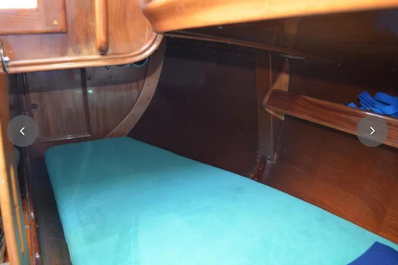 Slide: The Image of Cozy wooden cabin interior with teal bedding on an F&C 44 sailboat, 1980 model. - 37