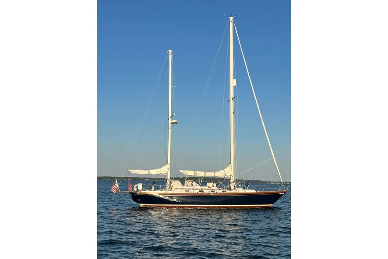 Slide: The Image of 1980 F&C 44 sailboat on calm water under clear blue sky. - 4