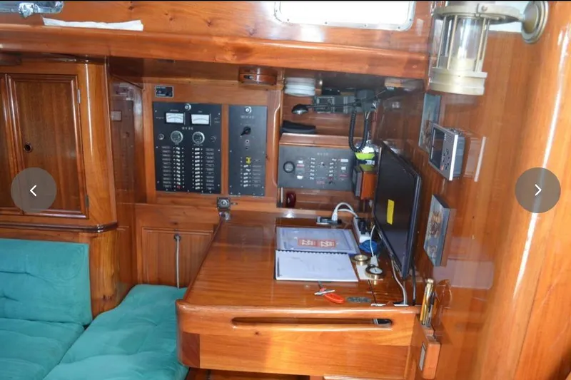 Slide: The Image of Wooden interior of 1980 F&C 44 yacht with control panel and desk area. - 42