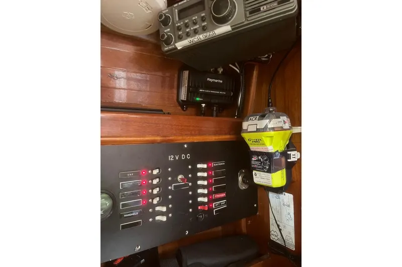 Slide: The Image of Electrical panel and radio equipment on 1980 F&C 44 boat, featuring 12V DC switches. - 43