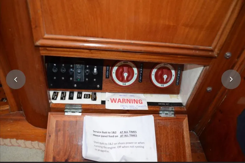 Slide: The Image of Electrical panel with switches and warning sign on 1980 F&C 44 boat. - 46