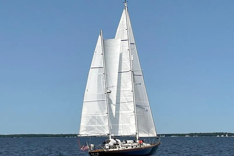 Slide: The Image of Sailing yacht F&C 44 from 1980 on open water under clear blue sky. - 6