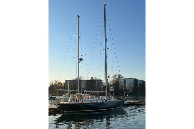 Slide: The Image of Sailboat docked at marina, F&C 44 model, 1980, with clear sky background. - 8