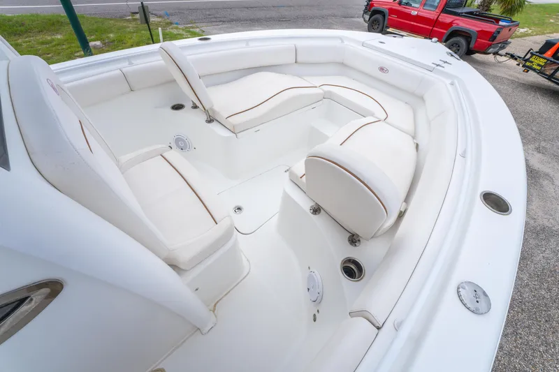 Slide: The Image of 2018 Sea Hunt Ultra 255 SE boat console with steering wheel, navigation display, and controls. - 12