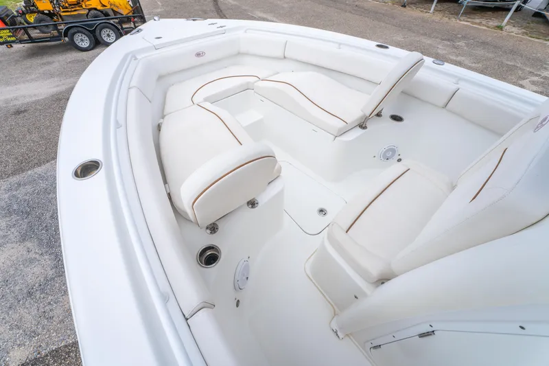 Slide: The Image of 2018 Sea Hunt Ultra 255 SE boat interior with white cushioned seating. - 13
