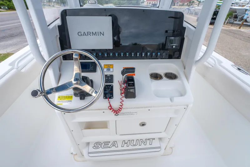 Slide: The Image of 2018 Sea Hunt Ultra 255 SE boat interior with white cushioned seating. - 14