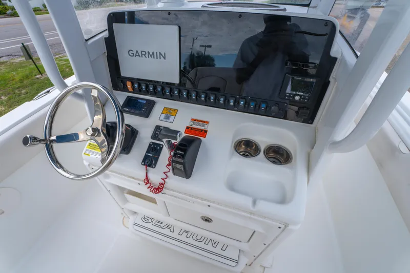 Slide: The Image of 2018 Sea Hunt Ultra 255 SE boat interior with white cushioned seating and Yamaha engine. - 17