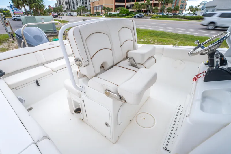 Slide: The Image of 2018 Sea Hunt Ultra 255 SE boat interior with white seating and storage. - 19