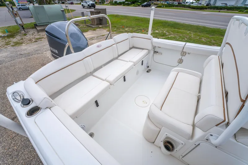 Slide: The Image of 2018 Sea Hunt Ultra 255 SE boat with blue T-top and rod holders. - 20