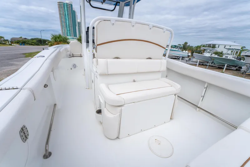 Slide: The Image of 2018 Sea Hunt Ultra 255 SE boat interior with white cushioned seating. - 22