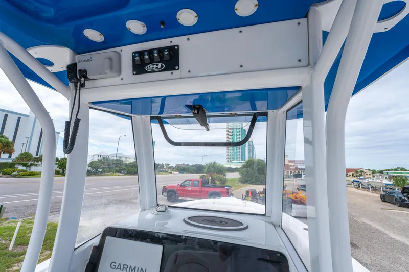 Slide: The Image of 2018 Sea Hunt Ultra 255 SE boat interior with compact marine toilet. - 24