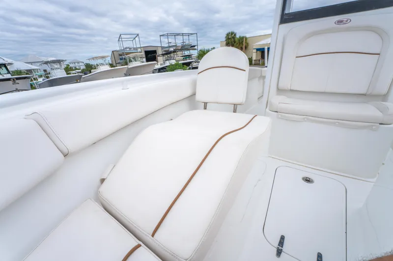 Slide: The Image of 2018 Sea Hunt Ultra 255 SE boat detail with logo and seating area. - 26