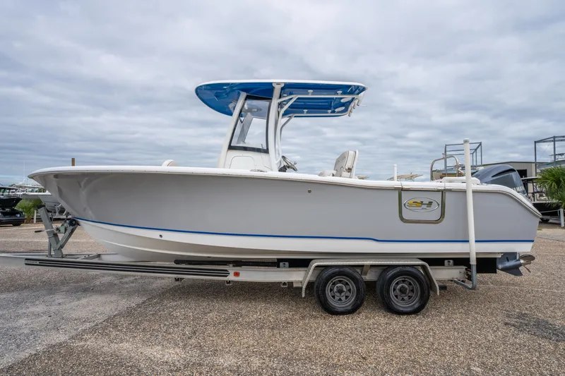 Slide: The Image of 2018 Sea Hunt Ultra 255 SE boat on trailer, side view under cloudy sky. - 3