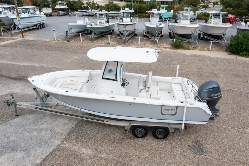 Slide: The Image of 2018 Sea Hunt Ultra 255 SE boat on trailer, parked in a marina lot. - 4
