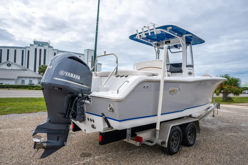 Slide: The Image of 2018 Sea Hunt Ultra 255 SE boat on trailer with Yamaha engine, parked outdoors. - 8