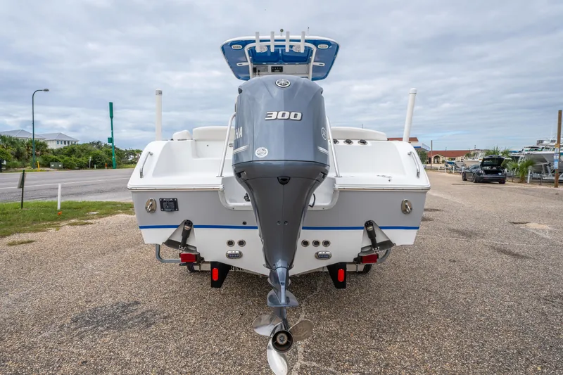 Slide: The Image of 2018 Sea Hunt Ultra 255 SE boat with Yamaha 300 engine, parked on a gravel lot. - 9