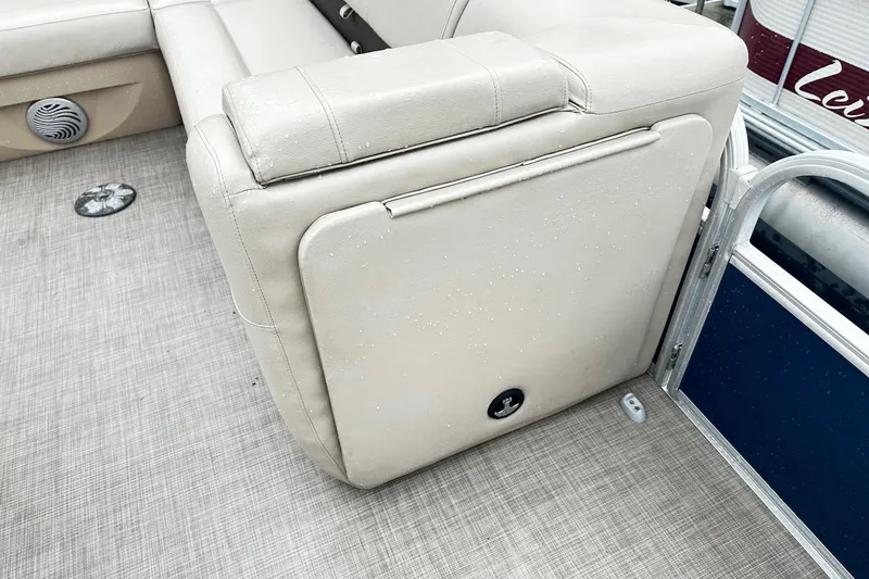 Slide: The Image of 2019 SUNTRACKER Party Barge Pontoon interior with beige seating and speaker detail. - 11