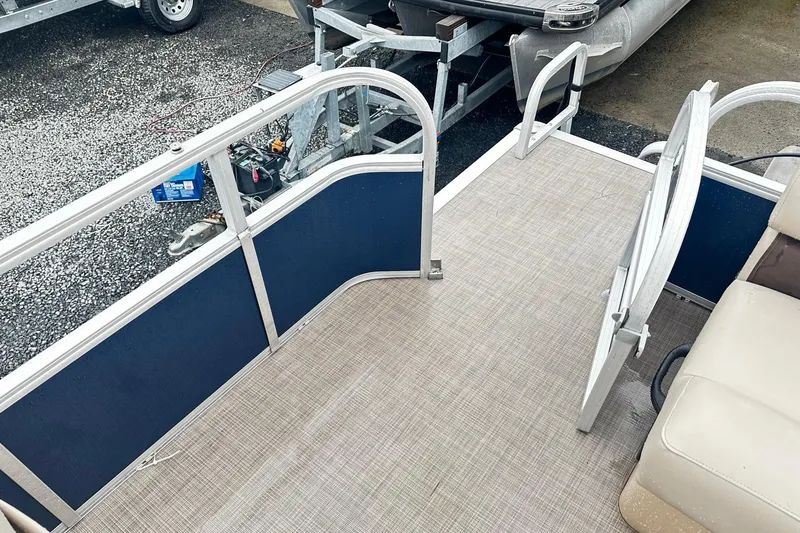 Slide: The Image of 2019 SUNTRACKER Party Barge Pontoon deck with seating and railing. - 12
