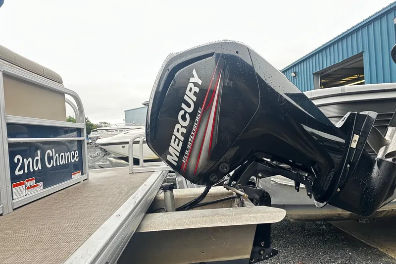 Slide: The Image of 2019 SUNTRACKER Party Barge Pontoon with Mercury outboard motor, docked at marina. - 14