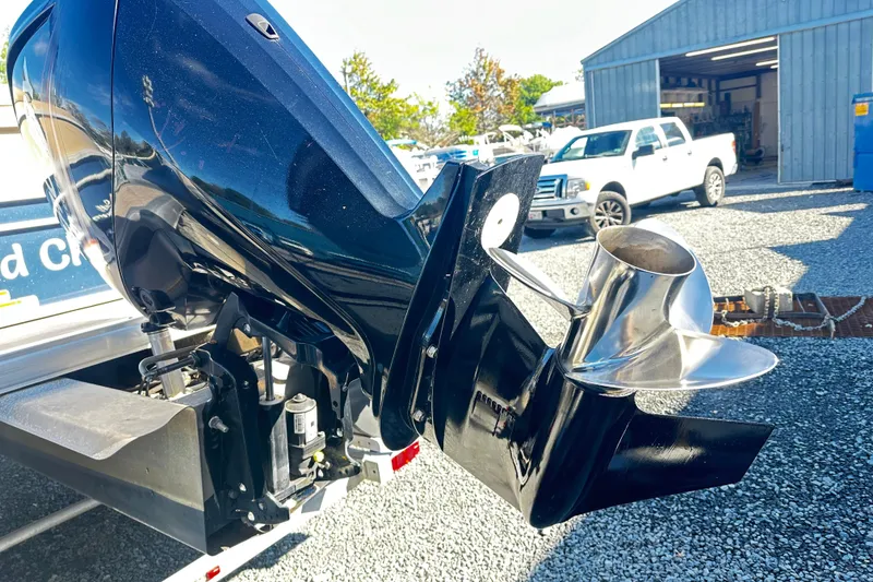 Slide: The Image of 2019 Sun Tracker Party Barge 200 outboard motor and propeller in a boatyard setting. - 25