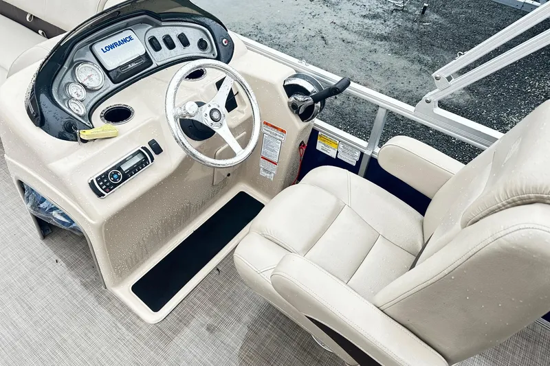 Slide: The Image of 2019 SUNTRACKER Party Barge Pontoon helm with steering wheel and control panel. - 3