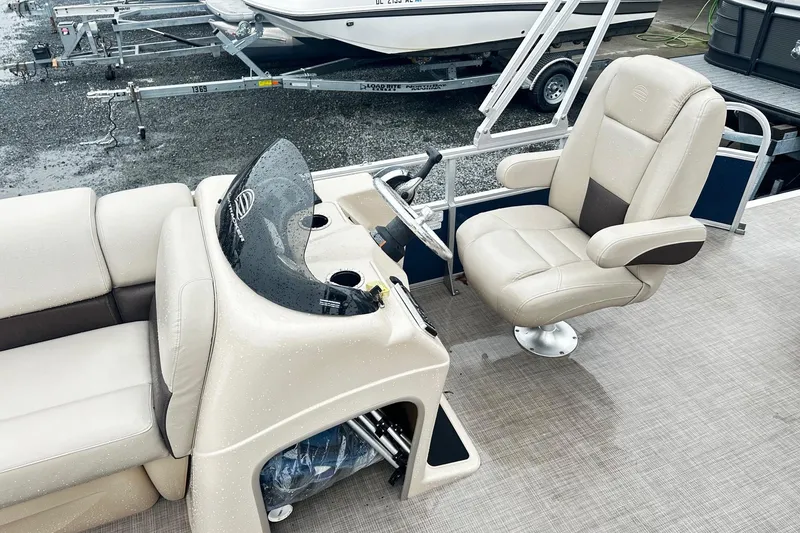 Slide: The Image of 2019 SUNTRACKER Party Barge Pontoon interior with captain's chair and console. - 4