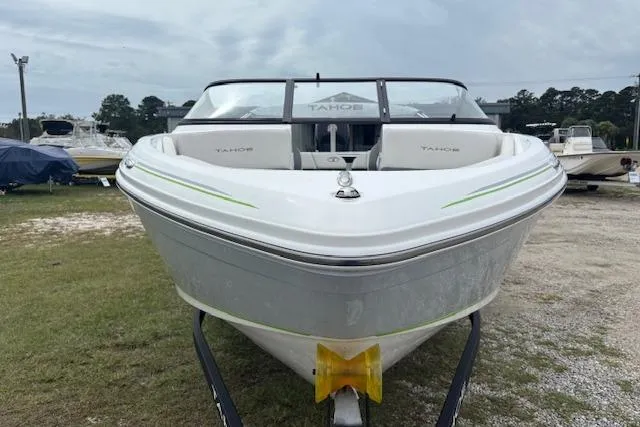 Slide: The Image of 2022 Tahoe 210 S boat on trailer, front view, parked outdoors. - 3