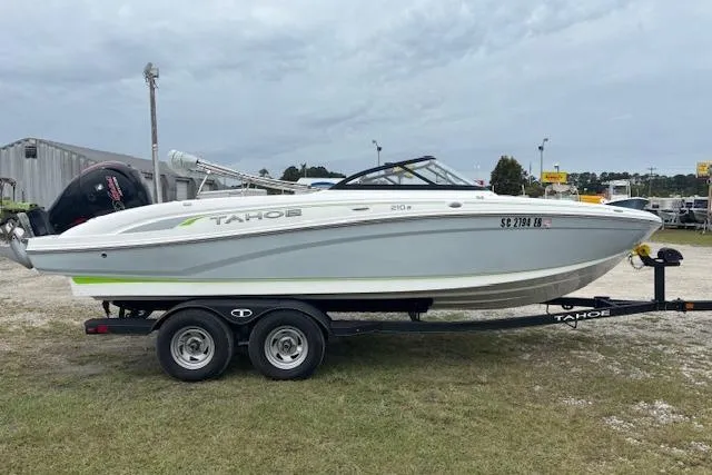 Slide: The Image of 2022 Tahoe 210 S boat on trailer, parked outdoors, side view. - 5