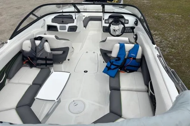 Slide: The Image of 2022 Tahoe 210 S boat interior with seating, steering wheel, and life jackets. - 9