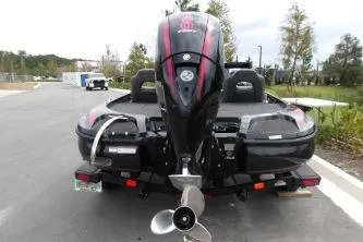 Slide: The Image of 2023 Nitro Z18 boat with outboard motor on trailer, parked outdoors. - 2