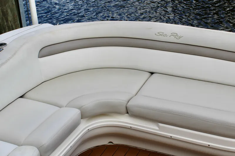 Slide: The Image of 2004 Sea Ray 340 Sundancer boat seating with white and gray upholstery. - 14