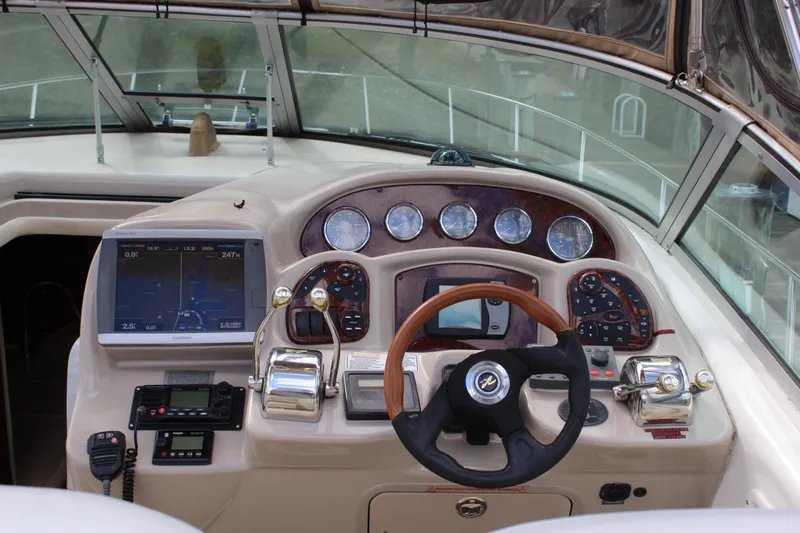 Slide: The Image of 2004 Sea Ray 340 Sundancer helm with navigation equipment and steering wheel. - 22
