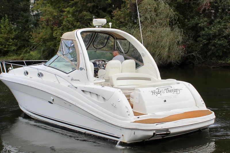 Slide: The Image of 2004 Sea Ray 340 Sundancer boat cruising on a calm river. - 4