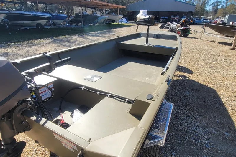 Slide: The Image of 2026 G3 Gator Tough 15 FL boat, olive green, parked outdoors on gravel. - 6
