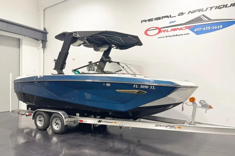 Slide: The Image of 2023 Nautique Super Air Nautique G23 boat on trailer in showroom. - 1