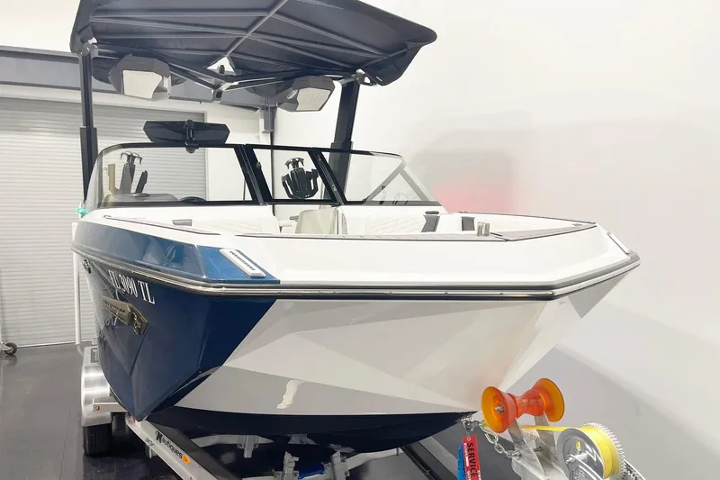 Slide: The Image of 2023 Nautique Super Air Nautique G23 boat in showroom, front view. - 2