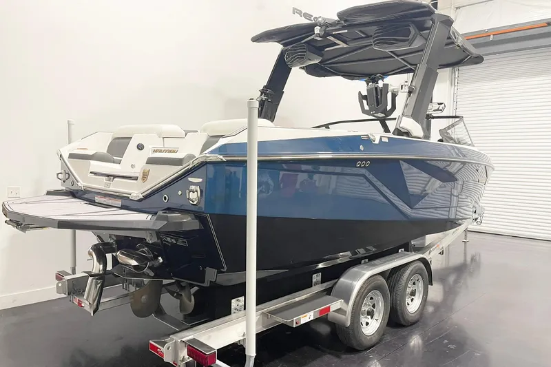 Slide: The Image of 2023 Nautique Super Air Nautique G23 boat on trailer in indoor storage. - 3