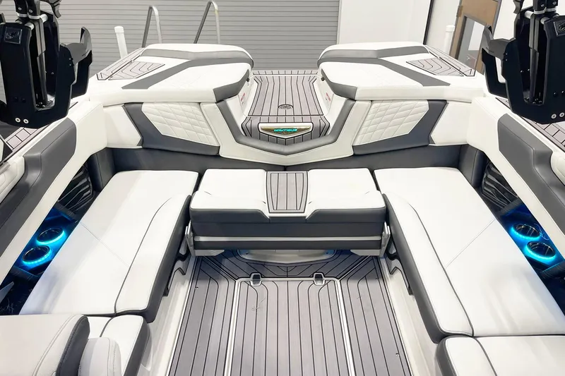Slide: The Image of 2023 Nautique Super Air Nautique G23 interior with luxurious seating and ambient lighting. - 9