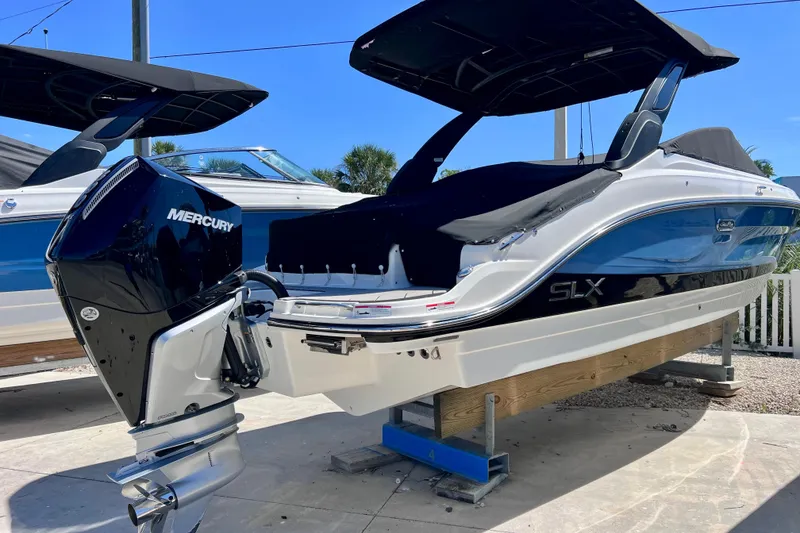 The Image of 2024 Sea Ray SLX 260 Outboard boat with Mercury engine, displayed outdoors. - 0