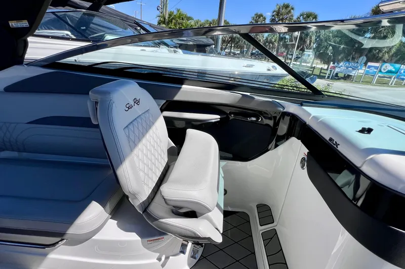 Slide: The Image of 2024 Sea Ray SLX 260 Outboard interior with luxurious seating and modern dashboard design. - 26