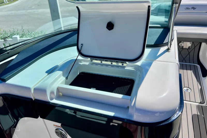 Slide: The Image of 2024 Sea Ray SLX 260 Outboard boat with open storage compartment on deck. - 36