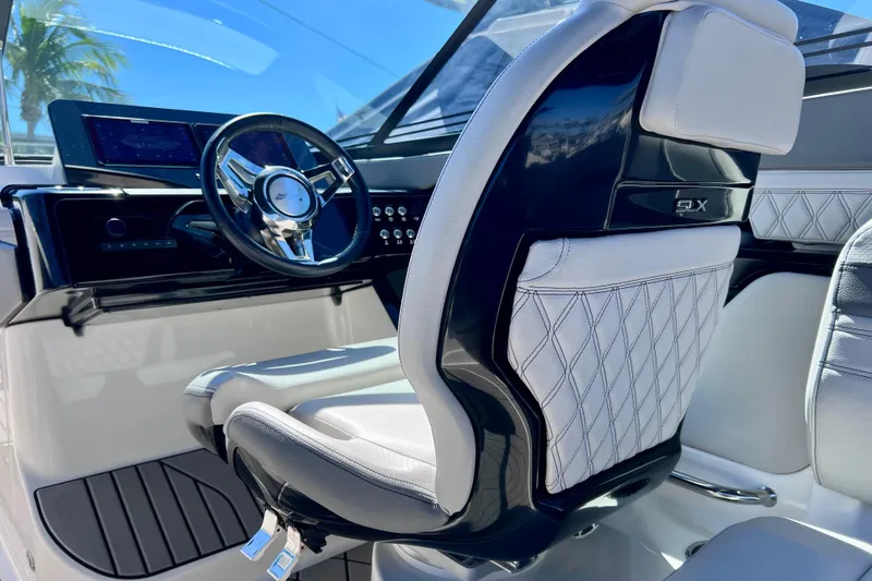 Slide: The Image of 2024 Sea Ray SLX 260 Outboard helm with luxurious seating and modern dashboard. - 37