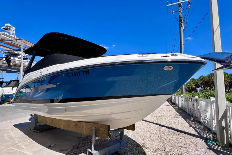Slide: The Image of 2024 Sea Ray SLX 260 Outboard boat on display under clear blue sky. - 4