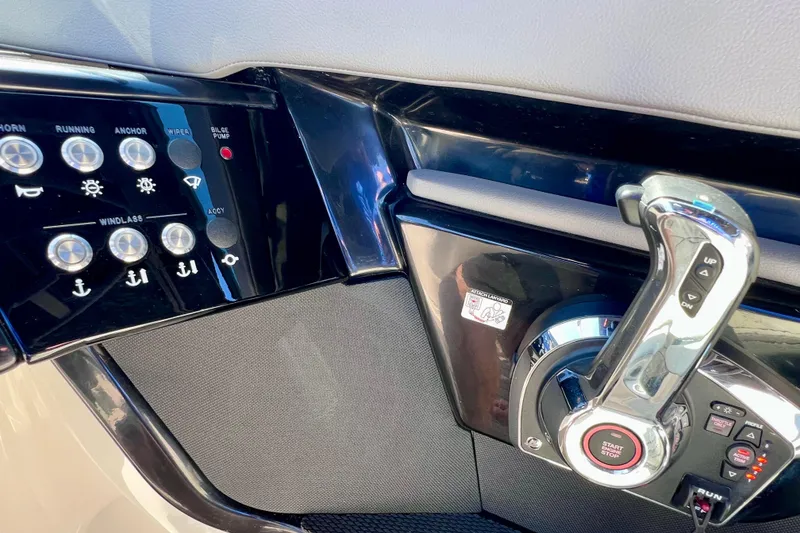 Slide: The Image of Control panel of 2024 Sea Ray SLX 260 Outboard boat with throttle and switches. - 48