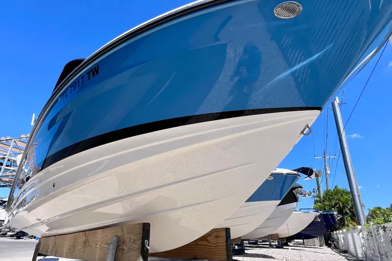 Slide: The Image of 2024 Sea Ray SLX 260 Outboard boat on display under clear blue sky. - 5