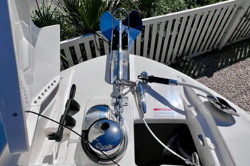 Slide: The Image of 2024 Sea Ray SLX 260 Outboard anchor system with polished metal components and safety warning. - 54