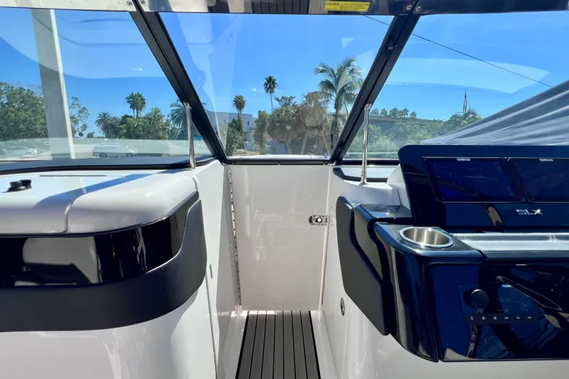 Slide: The Image of 2024 Sea Ray SLX 260 Outboard cockpit with modern dashboard and clear windshield. - 58