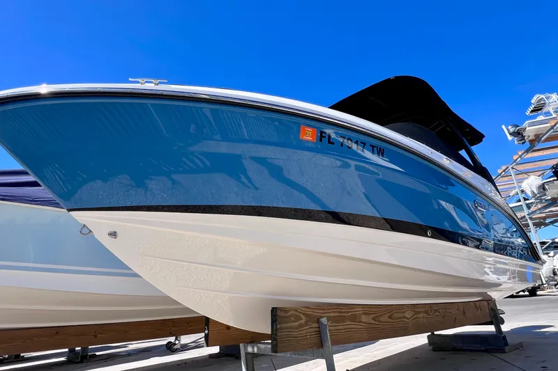 Slide: The Image of 2024 Sea Ray SLX 260 Outboard boat on display under clear blue sky. - 6