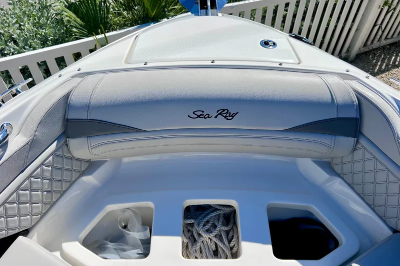 Slide: The Image of 2024 Sea Ray SLX 260 Outboard boat interior with storage compartments and elegant seating. - 66