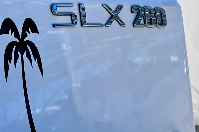 Slide: The Image of 2024 Sea Ray SLX 260 Outboard logo with palm tree graphic. - 69